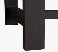 A dining table made in such a way that it can be extended or increased in size by the insertion of one or more leaves in the centre section of the table. Reed Extending Dining Table Pottery Barn