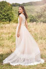 Alluring contrasts are glimpsed in pairings like twinkle and matte, giving each dress an unmistakable charisma that enhances the bride's own captivating charm. Lillian West Kollektionen Brautboutique