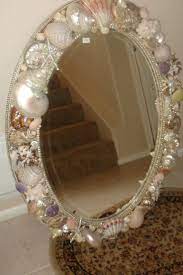 We converted the ikea malm dressing table into a fancied up makeup vanity by adding a mirror, hair appliance caddy and drawer. Seashell Mirror Seashell Bathroom Decor Mermaid Room Decor Mermaid Mirror