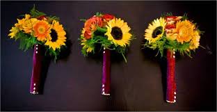 Wedding bouquets with sunflowers, white blooms, greenery for a cute rustic touch. Rich Fall Wedding Bridesmaids Bouquets With Sunflowers And Roses Wrapped With Satin Ribbon