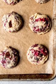 Soft And Chewy Raspberry Chocolate Chunk Cookies On A Piece Of Parchment Paper Raspberry Chocolate Chip Cookies Raspberry Cookies Raspberry Chocolate Chip