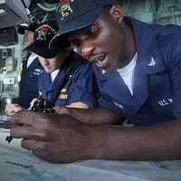 Electronics Technician 3rd Class Jonathan A. Simmons is lowered from the  forecastle during a man overboard drill aboard USS Denver (LPD 9).