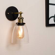 Glass wall light fixtures became a must have for anybody who want to set a beautiful home design in kitchens, living room or bathroom. Ambrose Antique Brass Wall Light Glass Shade Iconic Lights
