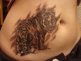 A sitting cat tattoo on the back near the shoulder; 40 Stylish Tiger Tattoos For Stomach
