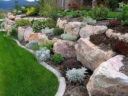 Boulder Retaining Wall Offers The Experience Of 200 000 Square Feet Of Rock Retainin Landscaping With Boulders Rock Garden Design Landscaping Retaining Walls