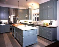 White kitchen cabinets or white subway tile pair nicely with a lemon accent wall. Blue Grey Kitchens