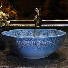 Inspired by dutch master paintings of the 17th century, the glorious pattern is abloom with peonies, dahlias, ranunculus, and hydrangea, dramatically lit on a dark backdrop in the style of chiaroscuro painting. Blue Flower Shape Ceramic Vessel Sink Pattern Painting Single Bowl