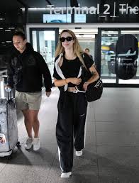 GK Barry looks fresh-faced as she arrives back in the UK from I'm A Celeb  with footballer girlfriend Ella Rutherford