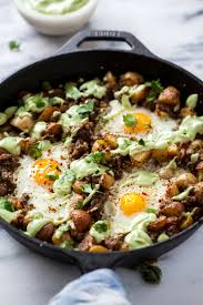 potato, beef & tomatillo salsa baked eggs with avocado crema. — quinn's  place