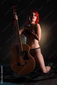 Eine nackte Frau mit Bassgitarre Stock Photo | Adobe Stock