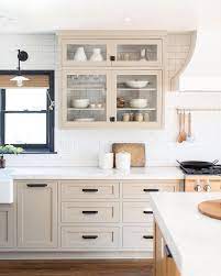White kitchen cabinets with pops of color from colonial white granite countertops and mosaic glass tile backsplash. 78 Greige Cabinets Ideas In 2021 Greige Cabinets Kitchen Inspirations Greige