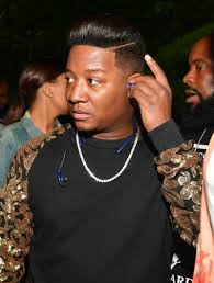 Cool black guy smiling with blue shirt. Male Celebrities With Perms Essence