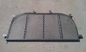 A cheap pair of tin snips from the dollar store work. Window Well Covers