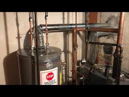 It typically has two brass clamps with a thick copper wire strung between them. Water Heater Install Bonding Tank Fixing Flue Pipe Youtube