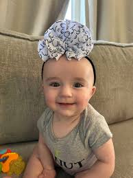 Baby girl loves her lovely bow and saves it