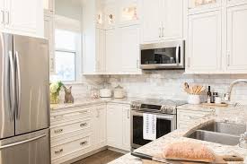 Small Beautifully Equipped U Shaped Kitchen Is Equipped With A Stainless Steel Wall Mounted Microwav Small White Kitchens Kitchen Remodel Small Kitchen Remodel