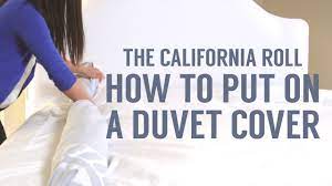Begin by laying the duvet cover flat on the bed with the cover opening facing towards you at the end of the bed. How To Put On A Duvet Cover The California Roll Way Youtube