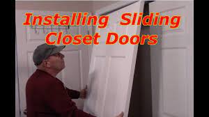 Next, carefully lift the door up at a slight angle to remove the bottom rollers from the track. How To Install Bypass Sliding Closet Doors Youtube