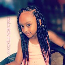 Double puffs crisscrossing on the head top. Image May Contain 1 Person Closeup Black Kids Hairstyles Kids Hairstyles Girls Hair Styles