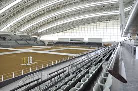 Al Shaqab Indoor Arena With Plastic Barriers Being Used To Divide The Arena Into Smaller Ones Stables Design Indoor Arena Horse Arena