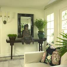 Buddha Sits On A High Table Overlooking A Simple Set Up Zenlife Zen Living Rooms Asian Home Decor Zen Decor