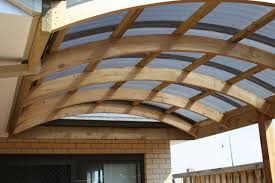 20' x 24' and he's using 6 pressure treated 6x6s 12' tall for the columns, roof trusses, osb plywood roof sheathing, shingles, double 2x8 beams and 4x4 lateral bracing for the columns (with 1' of overhang). Curved Roof Verandah Building A Carport Free Standing Carport Carport Plans