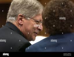 Durham District Attorney Mike Nifong (left) sits with his legal team Dudley  Witt (center) and David Freedman (right) as they confer