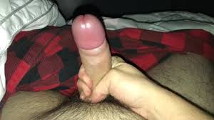 Fit guy makes his big dick ejaculate while laying in his bed