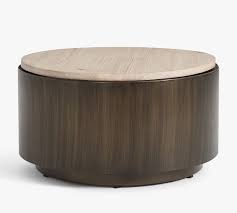 Lower shelf is covered in tightly woven rattan peel. Gilman 30 Round Storage Coffee Table Pottery Barn