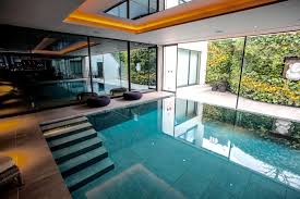 An indoor swimming pool, jacuzzi, steam room and comfortable poolside area are just a few things which have transformed this london home. Indoor Swimming Pool Clear Water