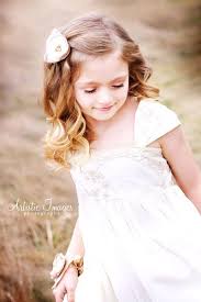 While you may spend most of your time finding the perfect dress and keeping your bridesmaids in line, don't forget the importance of the flower girl hairstyle. Sweet Curly Flower Girl Hairstyle With Flower Deer Pearl Flowers
