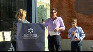 Historic Espy House hold ribbon cutting for distillery