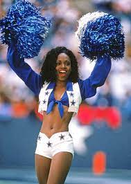 See The Dallas Cowboys Cheerleader Uniform Through The Years Dallas Cowboys Cheerleaders Black Cheerleaders Cheerleading