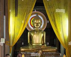 Two Buddhist monks meditating inside a serene Cambodian temple