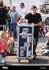 A roadie moving an equipment box through people at a summer festival Stock  Photo - Alamy