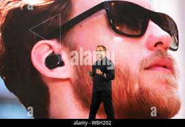 Steve Sinclair, Vice President of product management of Motorola Mobility,  introduces the Moto Hint bluetooth headset at the launch ceremony for the M  Stock Photo