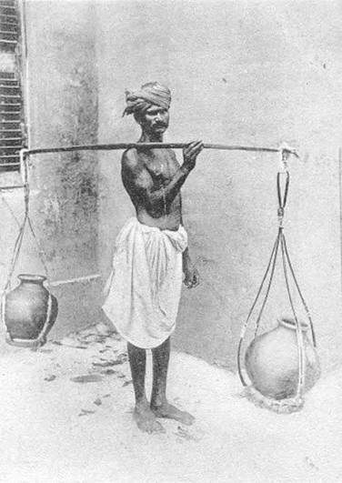 Old picture of Madras women carrying cow dung.