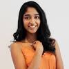 Ramakrishnan has a tan skin tone and long curly black hair. 1