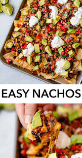 Nachos Layered With A Crisp Tortilla Chips A Simple Seasoned Ground Beef And Black Bean Layer Shredded Tangy Ch Easy Nachos Nachos Recipe Easy Nachos Recipe