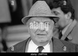 Reputed Mafia boss Carlos Marcello (at left of center background with dark  tie) flanks the pallbearers carrying the remains of his mother during  funeral services Sept. 9, 1971 at Gretna, Louisiana. Mrs.