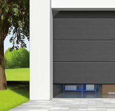 A sectional door is constructed of panels that retract up and over the floor space, resting parallel with the ceiling. Sectional Garage Doors Novoferm Group