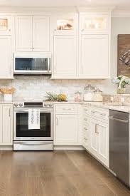 White U Shaped Kitchen Boasts Square Cabinets Fitted With Custom Lighting And Stacked Above White Custom Kitchen Cabinets Design Kitchen Cabinet Design Kitchen