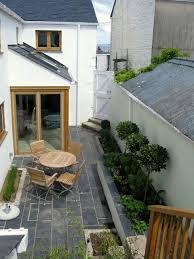 Small Seaside Protected Courtyard Patio Slate Pavers And Wall Coping Bay Tree Topiaries Garden Design By Jo Pe Courtyard Gardens Design Cottage Garden Patio