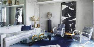 This modern living room showcases bright orange walls contrasted with a grey sofa, round coffee table, and pendant lights. 35 Best Gray Living Room Ideas How To Use Gray Paint And Decor In Living Rooms
