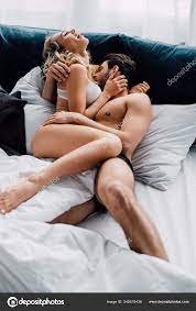 漂亮男人在床上亲吻兴奋女人的胸膛— 图库照片©VitalikRadko＃349519436
