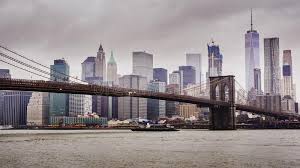 Brooklyn is a borough of new york city, coextensive with kings county, in the u.s. Manhattan And Brooklyn Bridge New York City Fast Clouds Float Over The Skyscrapers Cloudy Weather Heavy Traffic On Stock Image Image Of Manhattan Cloud 132171225