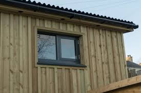 Azek cladding delivers the full aesthetic experience of wood without the laborious, costly, and constant upkeep required with traditional lumber. Board And Batten Workshops Black Lodge Cabins