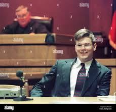 Former Air Force Academy cadet David Graham, 20, smiles while judge Don  Leonard sits in the background at the courthouse in New Braunfels, Texas.  Graham is