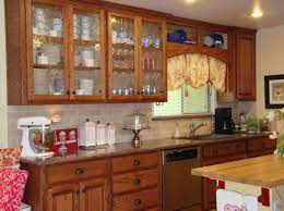 This crisp white cabinet is equipped with a spacious top and shelf for ample display space. Kitchen Cabinets With Glass Glass Kitchen Cabinets Glass Kitchen Cabinet Doors Wooden Kitchen Cabinets