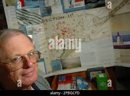Eugene Ballance sits in front of a map he made Wednesday, May 2, 2007, at  his home in Ocracoke, N.C. Ballance used maps made 100 years ago to locate  oyster beds off